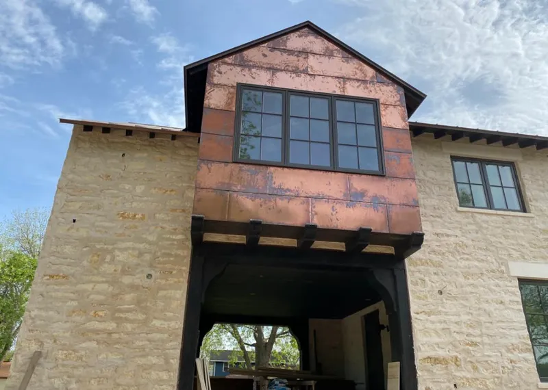 Copper metal panel facade on a stone building for Skylight Installation in Thornton